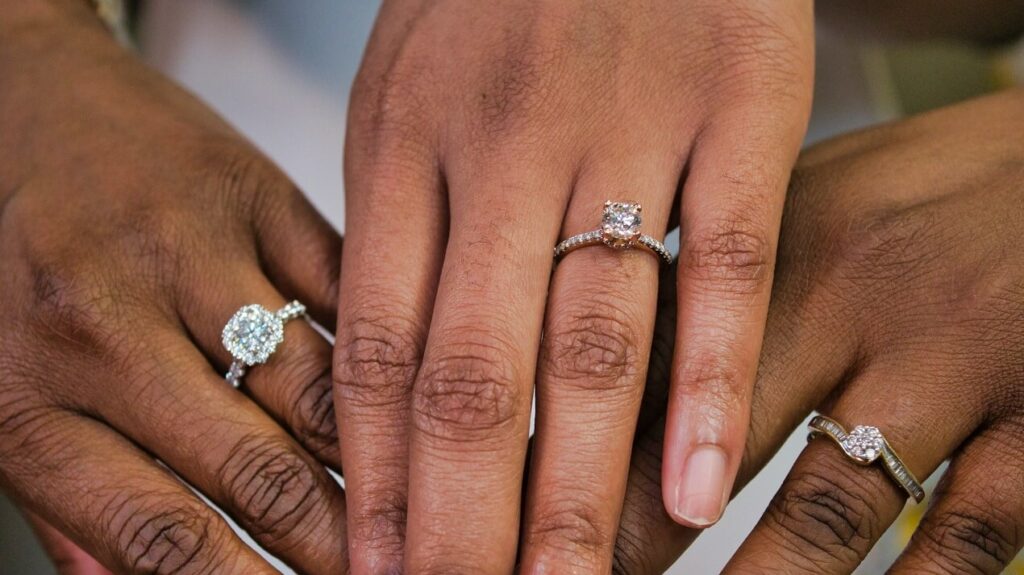 Three diamond engagement rings in different settings.