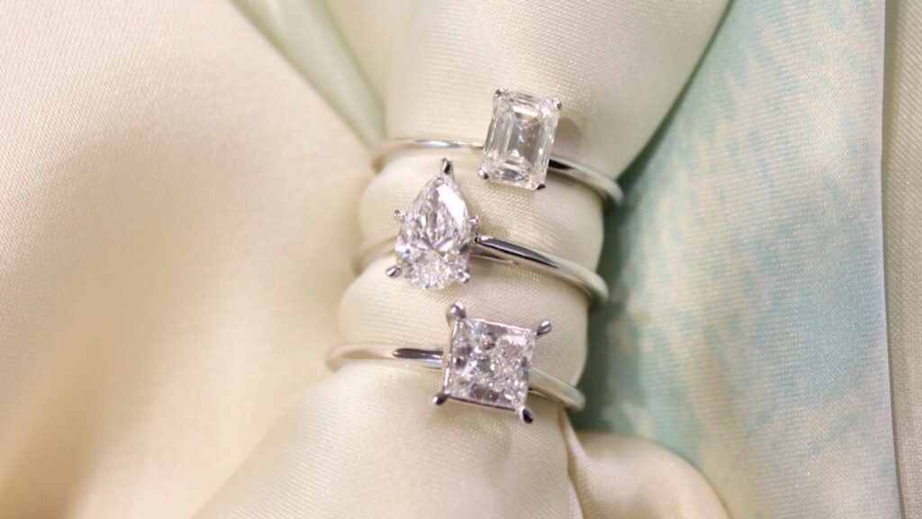 Engagement rings with different diamond shapes - princess, emerald and pear.