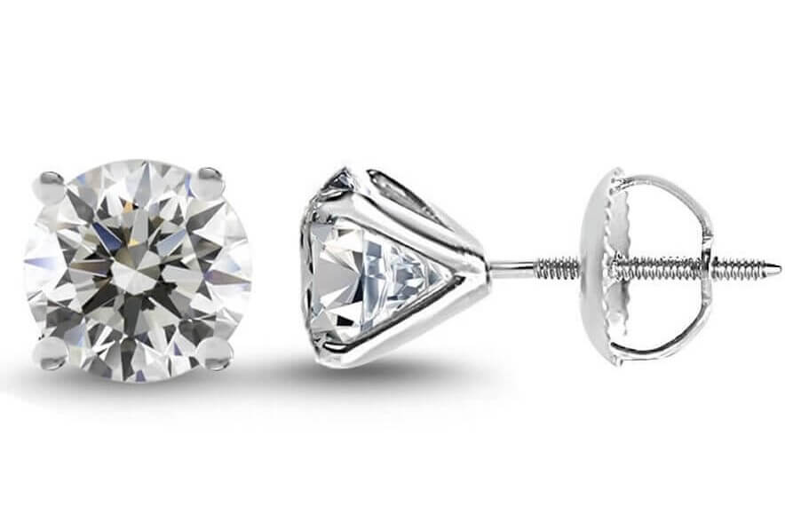 A pair of diamond stud earrings in martini setting with screw-backs.