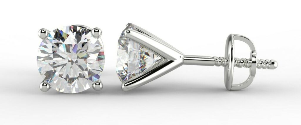 A pair of diamond stud earrings in martini setting with screw-backs.