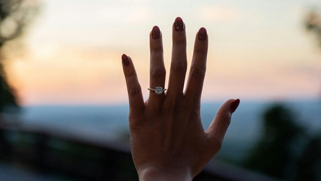 Diamond engagement ring worn on a hand